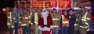 Santa, flanked by fellow volunteer firemen, in Norfolk, Conn.